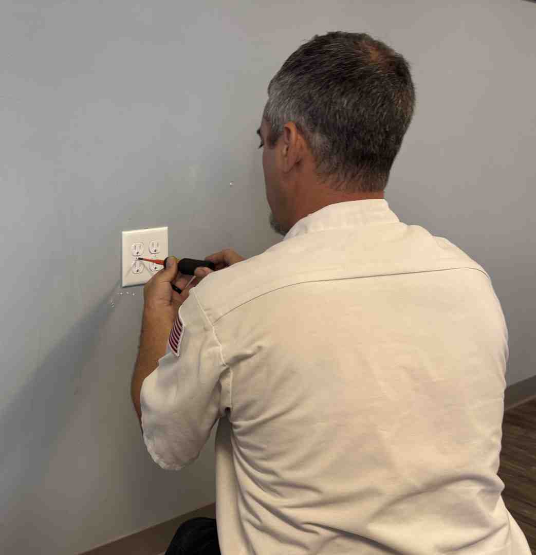 close-up of electrician hands working on electrical panel with safety equipment - electrical services near me close-up of electrician hands working on electrical panel with safety equipment - electrical services near me