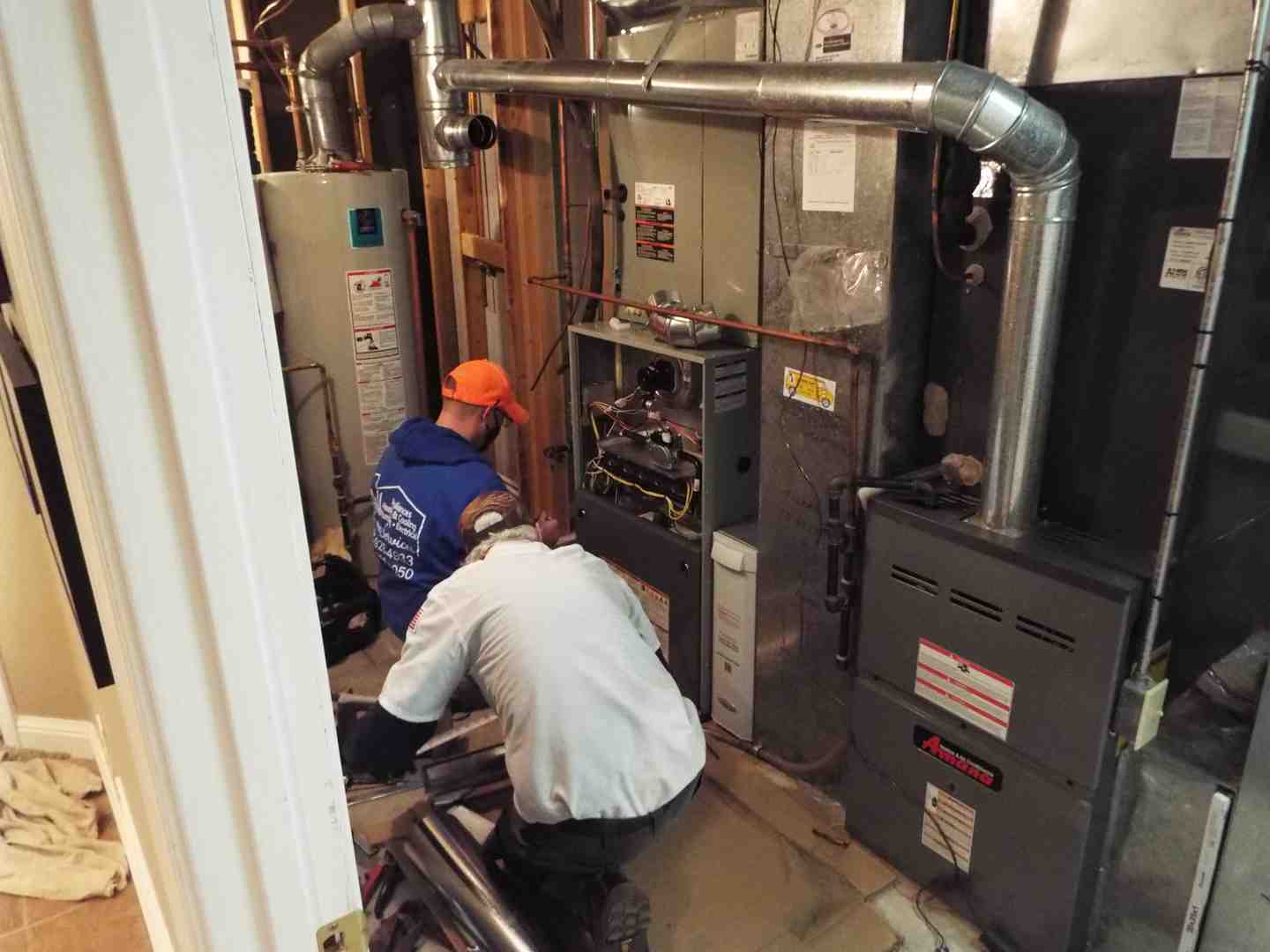 Professional technician repairing water heater - water heater repair Professional technician repairing water heater - water heater repair