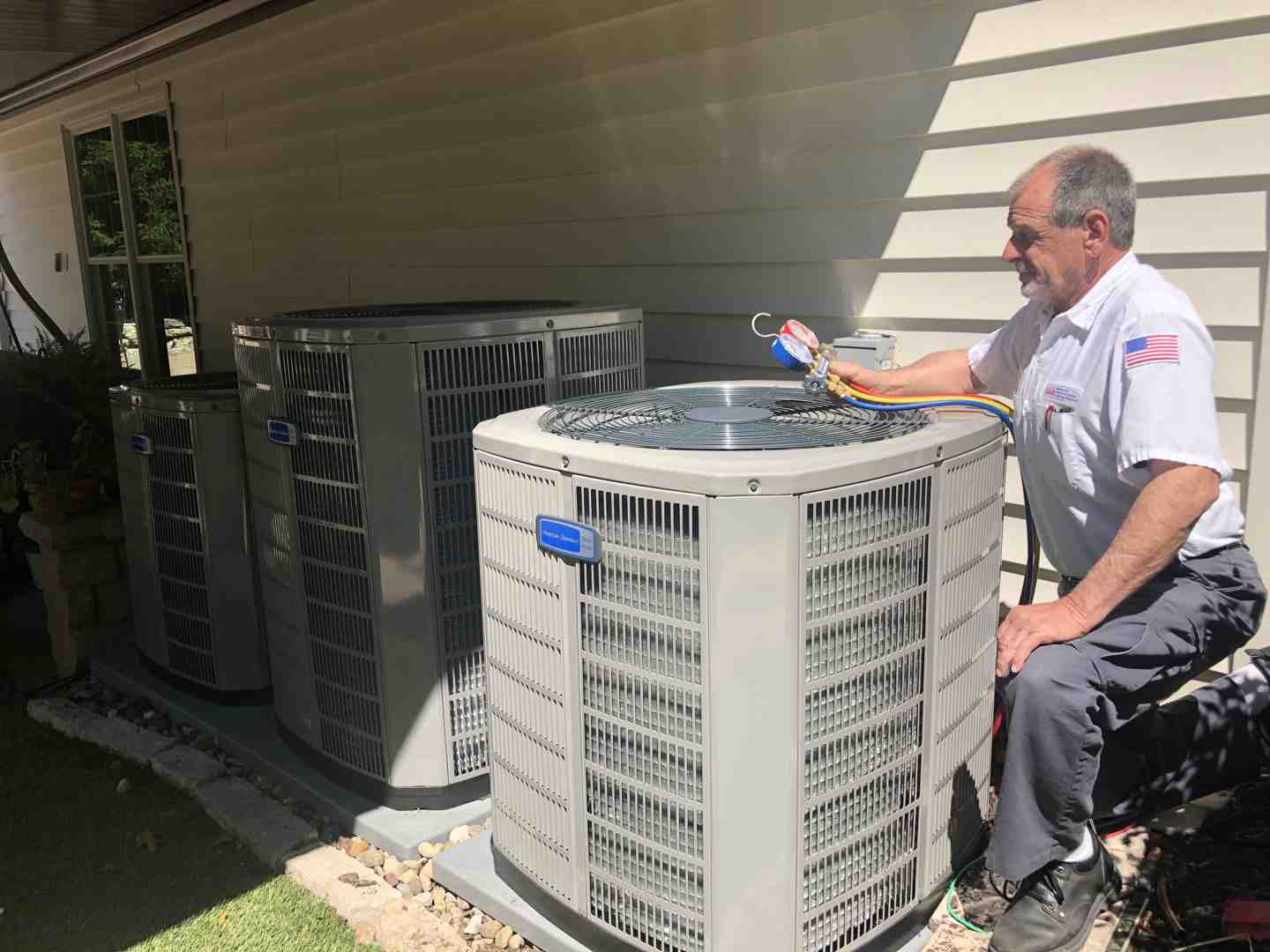 certified technician carefully inspecting an outdoor AC unit - home heating and cooling certified technician carefully inspecting an outdoor AC unit - home heating and cooling