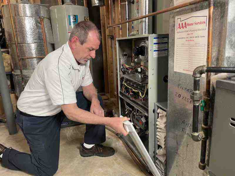 technician lubricating a motor bearing - heating and air maintenance near me technician lubricating a motor bearing - heating and air maintenance near me