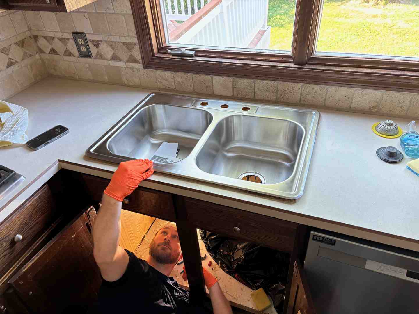 Image of a new, gleaming kitchen faucet being installed - Sink repair O'Fallon Image of a new, gleaming kitchen faucet being installed - Sink repair O'Fallon