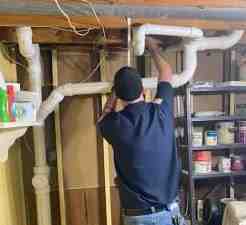 a technician performing a video camera inspection of a pipe - drain and plumbing services a technician performing a video camera inspection of a pipe - drain and plumbing services