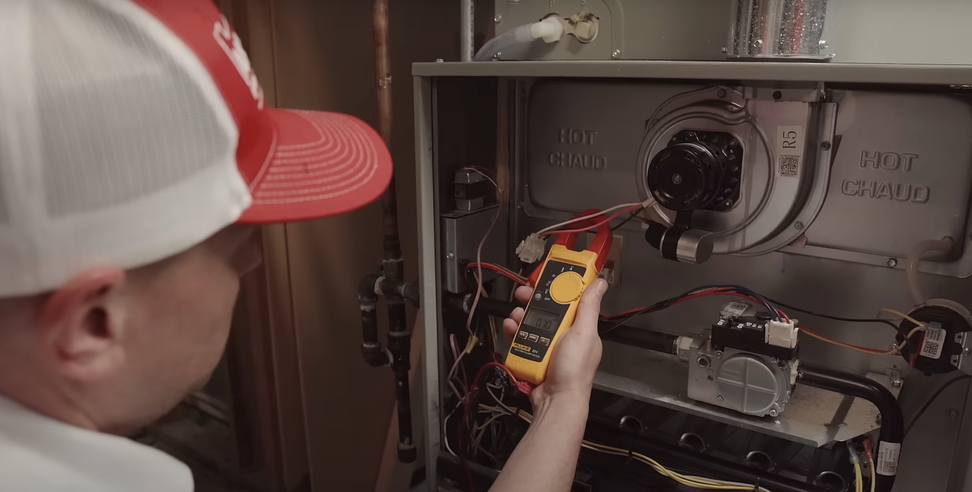technician inspecting electrical connections on a furnace - heating and air maintenance near me technician inspecting electrical connections on a furnace - heating and air maintenance near me